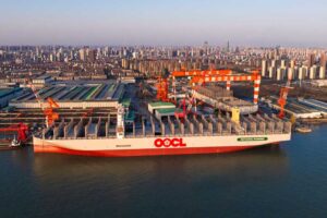 Container ship "OOCL Wisdom" in front of the premises of Nantong Cosco KHI Ship Engineering