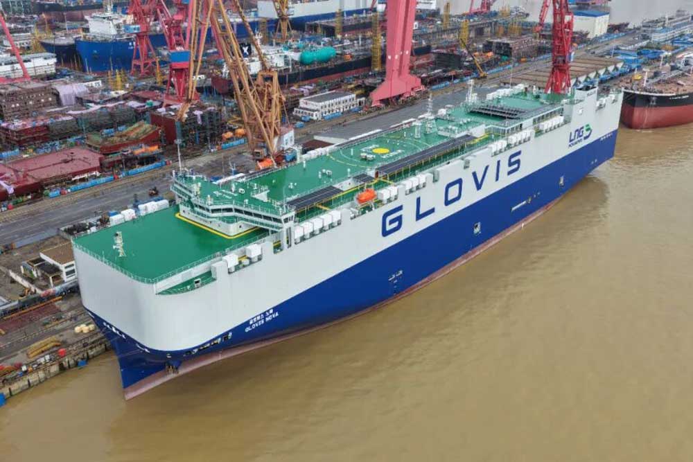 The car carrier ‘Glovis Nova’ in Shanghai, with a harbour in the background