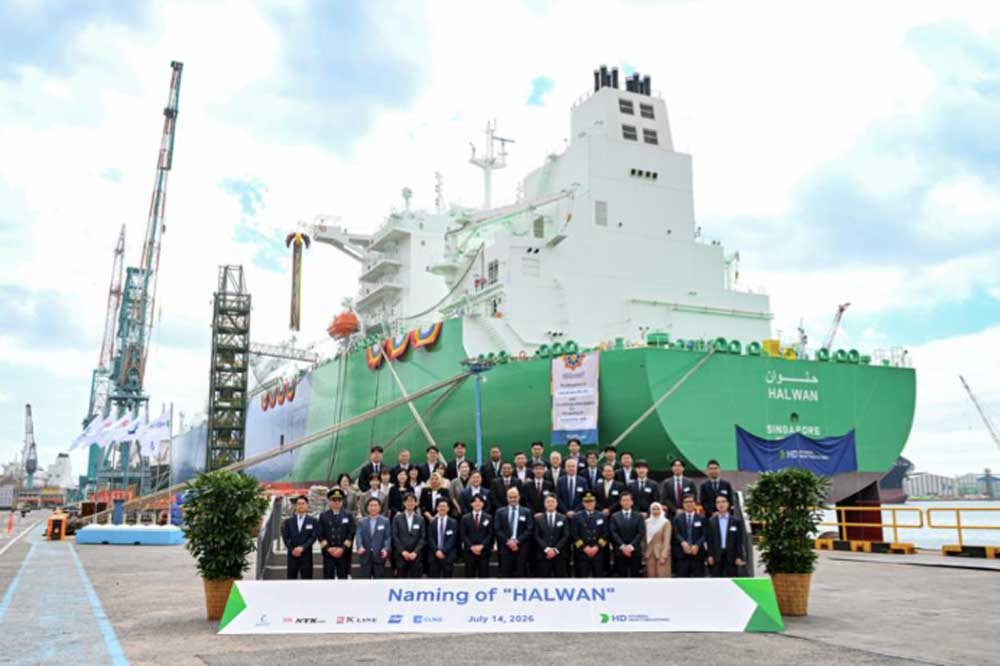 The christening of the LNG tanker ‘Halwan’; a group of people in front of a green tanker