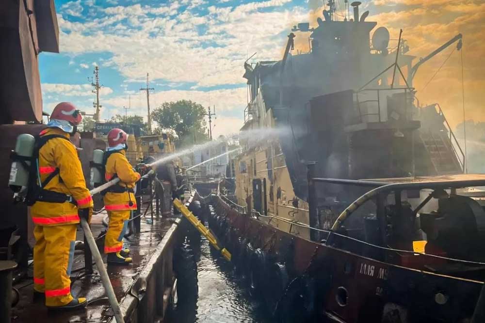 Firefighters are putting out a burning tractor