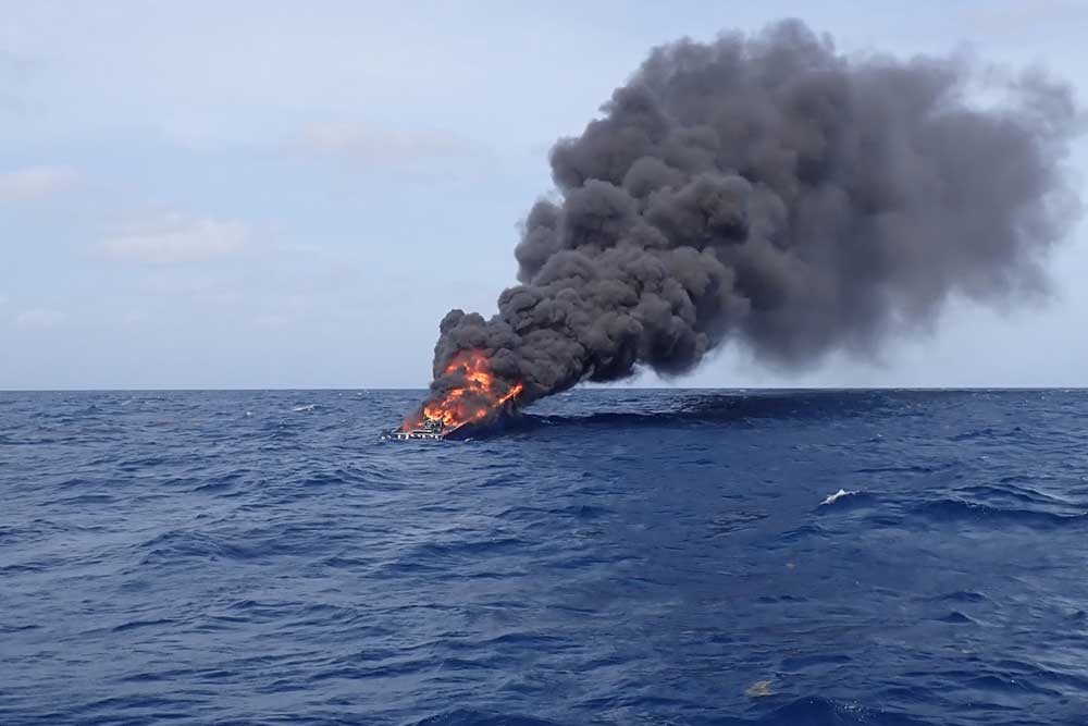 A boat on fire at sea
