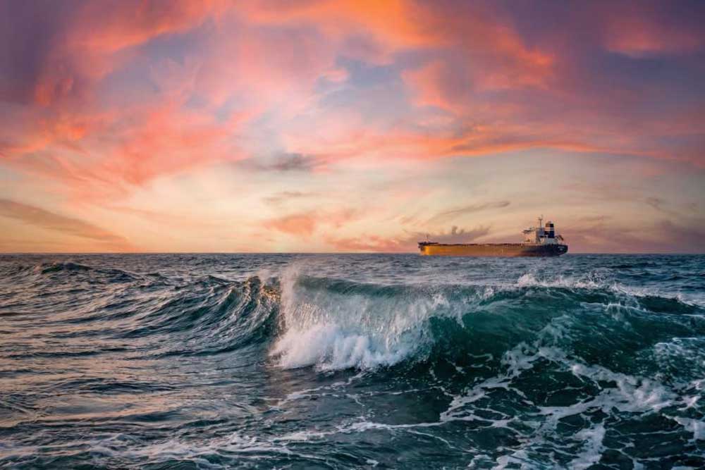 A view of a ship sailing across the sea in the distance