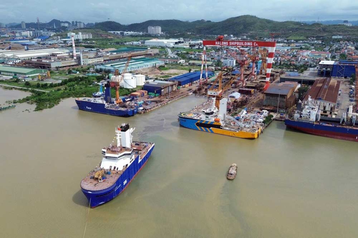 A view of a shipyard in Vietnam; in the foreground, a ship leaving the shipyard
