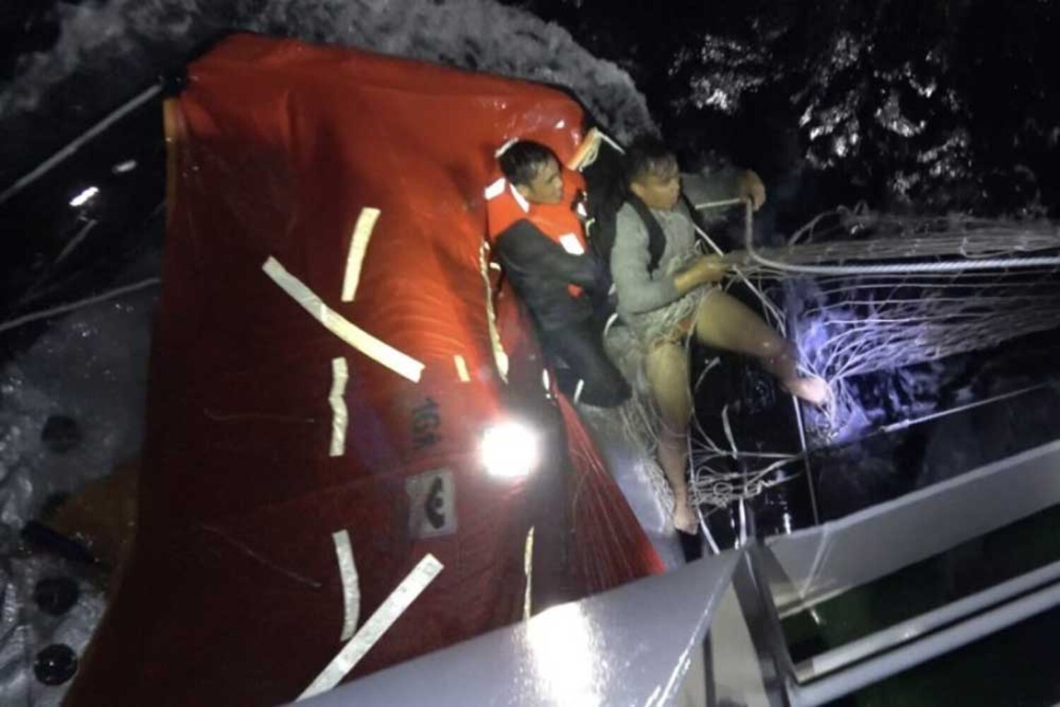 Rescue of seamen in the South China Sea, lifeboat at night