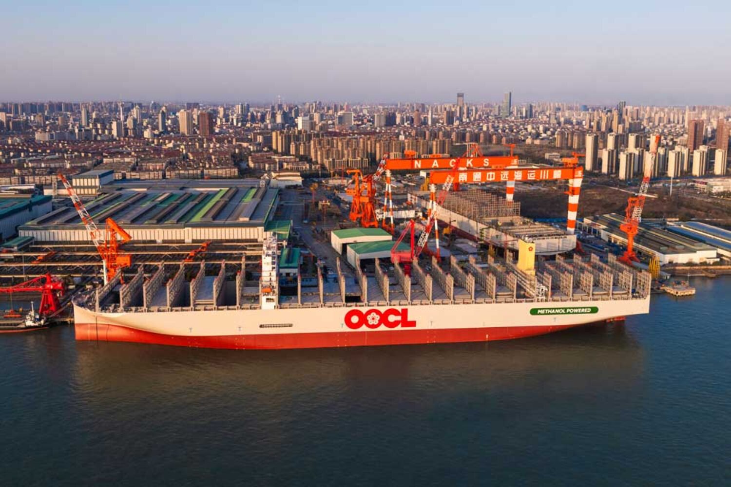 Container ship "OOCL Wisdom" in front of the premises of Nantong Cosco KHI Ship Engineering