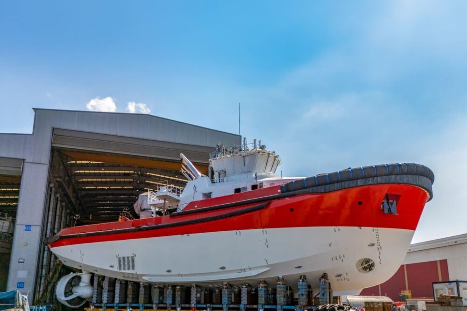 A new tugboat building in front of the shipyard hall